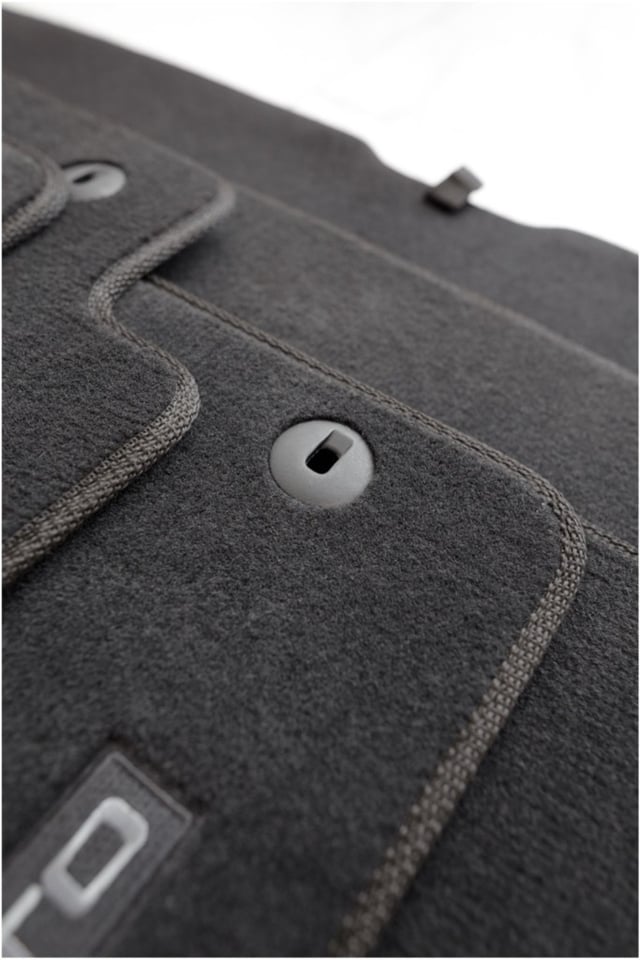 Close-up of Lecatris custom carpet floor mats with embroidered Sportage, Rio, Sorento and Soul logos