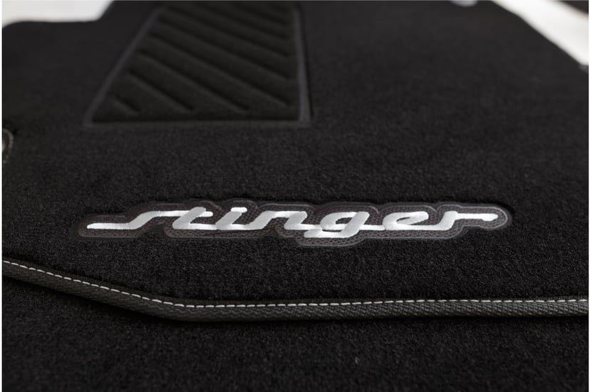 Close-up of Lecatris custom floor mat with embroidered Stinger logo and heel pad detail